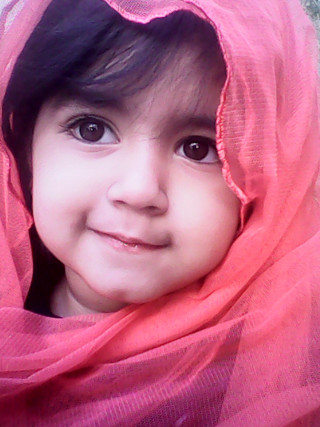Little girl pink scarf smiling - a little girl free wallpaper for mobile