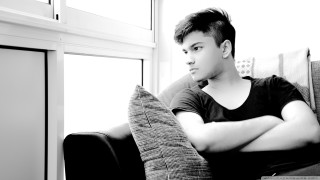 Man sitting couch arms crossed 2 - jayison devadas free wallpaper