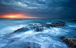 Sunset ocean rocks dark sky 2 - a dark sky in the background free wallpaper for desktop