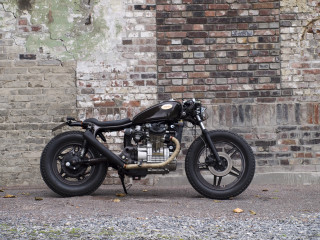 Motorcycle parked brick wall black - assemblage free wallpaper