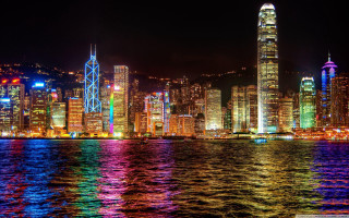 City skyline night lights bright - a large body of water in front free wallpaper