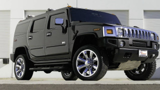 Hummer truck parked building garage - a garage door open free wallpaper