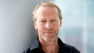 Man black shirt leaning wall - against a wall free wallpaper