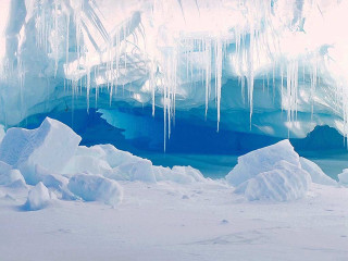 Large iceberg person standing ice - side and a person free wallpaper