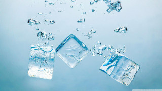 Three ice cubes floating in - a white border free wallpaper
