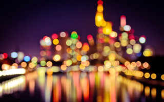 Blurry city night lights reflection - the water and buildings free wallpaper