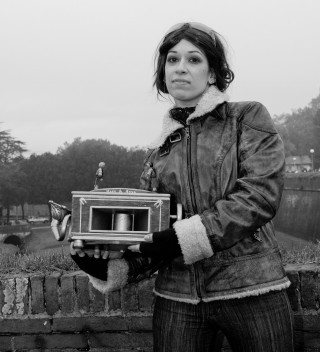 Woman holding small box clock - a stone wall free wallpaper for tablet