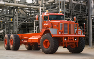 Large orange truck factory pipes - hard surface free wallpaper