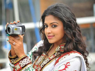 Woman colorful dress holding camera - movie still frame free wallpaper