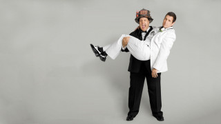 Two men tuxedos posing picture - one holding free wallpaper