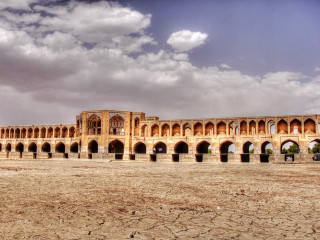 Large building arches sky clouds - a few person free wallpaper