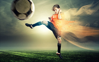 Young boy kicking soccer ball - andrew robertson free wallpaper