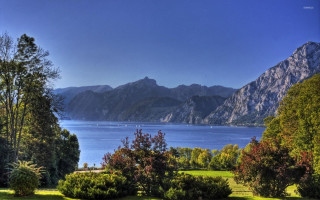 Scenic lake mountains trees bench - a scenic view of a lake free wallpaper