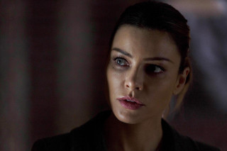 Woman serious dark room curtains - a curtain behind her free wallpaper