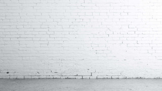 Person standing white brick wall - a white brick wall free wallpaper