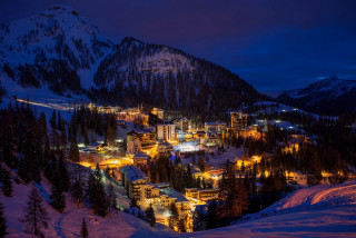 Snowy mountain town lit night - snow and trees free wallpaper