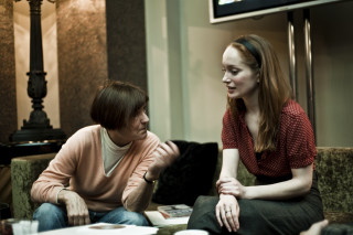 Woman sitting couch red shirt - a pink sweater free wallpaper