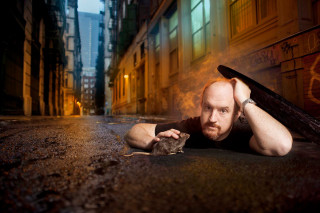 Man rat ground graffiti building - his hand and a building in the background free wallpaper