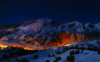 Snowy mountain lit area night - backlight free wallpaper