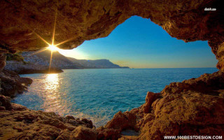 Ocean view cave beach sunset - the sun shining free wallpaper