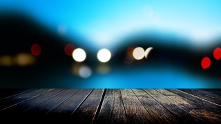 Wooden table blurry lights lake 3 - a tilt shift photo free wallpaper