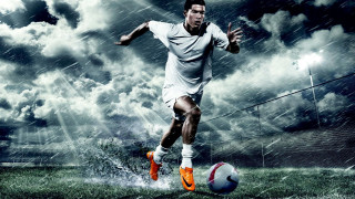 Man kicking soccer ball rain - a cloudy sky behind free wallpaper
