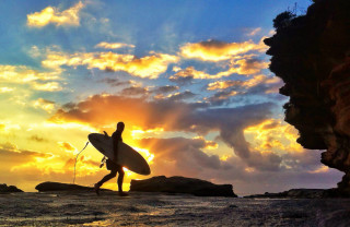 Person walking beach surfboard cloudy - the sun setting free wallpaper