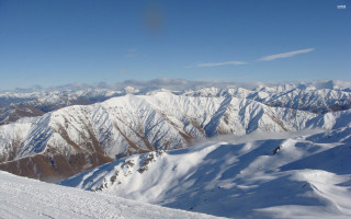 Snowboarder snowy mountain top background 2 - a snowboard free wallpaper