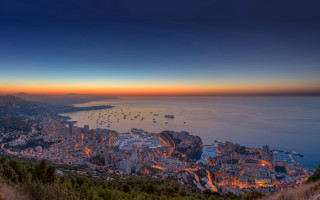 City lit night ocean mountains - panoramic free wallpaper