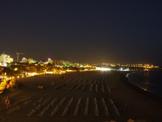 Beach chairs tables nighttime city - city free wallpaper