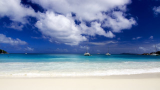 Beach boats clouds white sand - a white sand beach free wallpaper for desktop