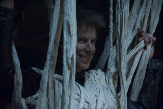 Smiling man holding rope structure - sinister free wallpaper