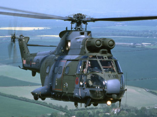 Helicopter flying lush green countryside - a helicopter free wallpaper