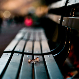 Bench wood closeup blurry background - a tilt shift photo free wallpaper for tablet