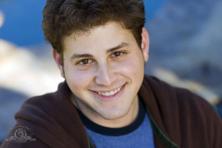 Man brown jacket smiling mountain - fletcher martin free wallpaper