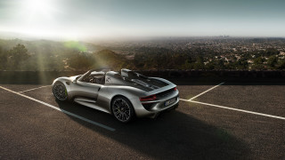 Silver sports car backlit city - a city in the distance free wallpaper