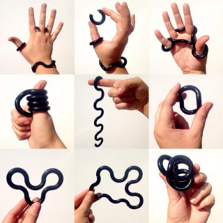 Hands holding black object spiral - a sery of photos free wallpaper