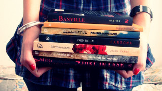 Woman holding stack of books - a stack of books free wallpaper