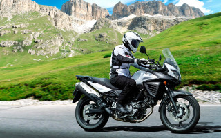 Man motorcycle road green hillside - a lush green hillside free wallpaper