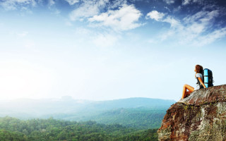 Person sitting rock mountains trees - a sky background and a person free wallpaper