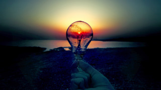 Hand lightbulb sunset water background 2 - a light bulb free wallpaper