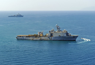 Large ship ocean small ship - a jigsaw puzzle free wallpaper