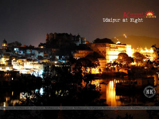 City night lights buildings trees - the foreground and a body of water free wallpaper