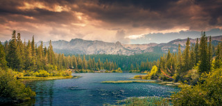 River trees mountains cloudy sky 7 - a sunbeam in the distance free wallpaper