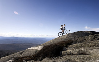 Man biking rocky hill valley - a bike free wallpaper