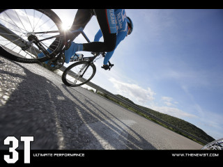 Person riding bike street hill - dynamic camera angle free wallpaper