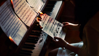 Woman playing piano sheet music - a piano free wallpaper