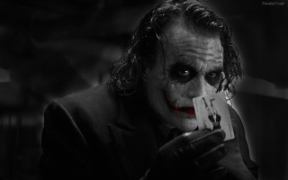 Joker man serious card holding - a card free wallpaper