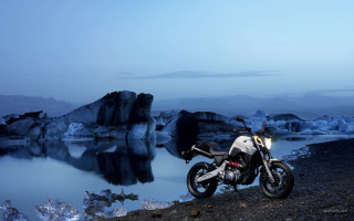 Motorcycle rocky shore water icebergs - iceberg free wallpaper