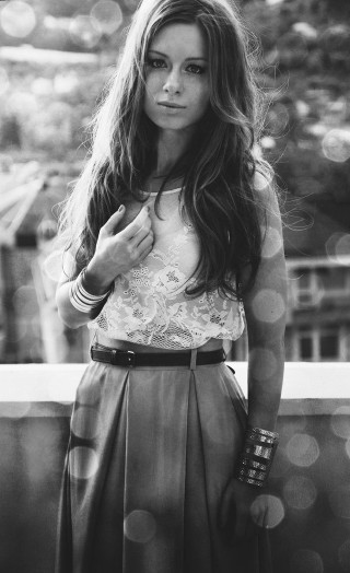 Woman balcony serious look camera - fashion photography free wallpaper for mobile